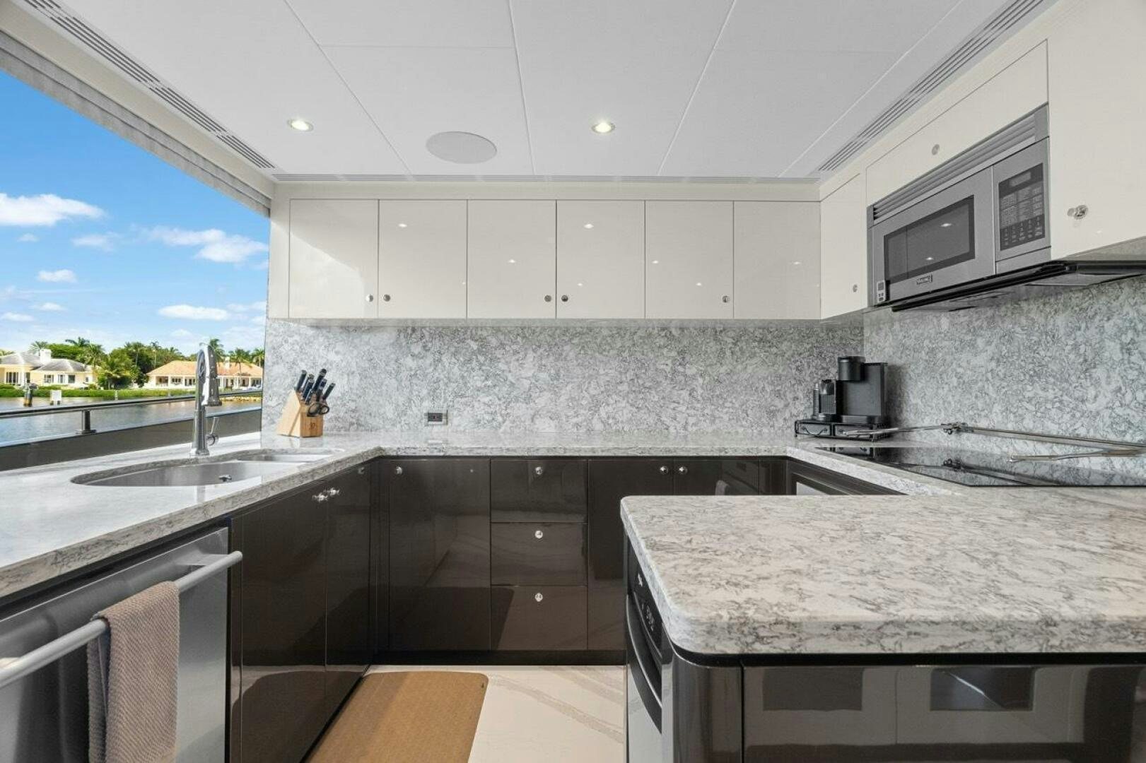 a kitchen with white cabinets aboard LADY G Yacht for Sale