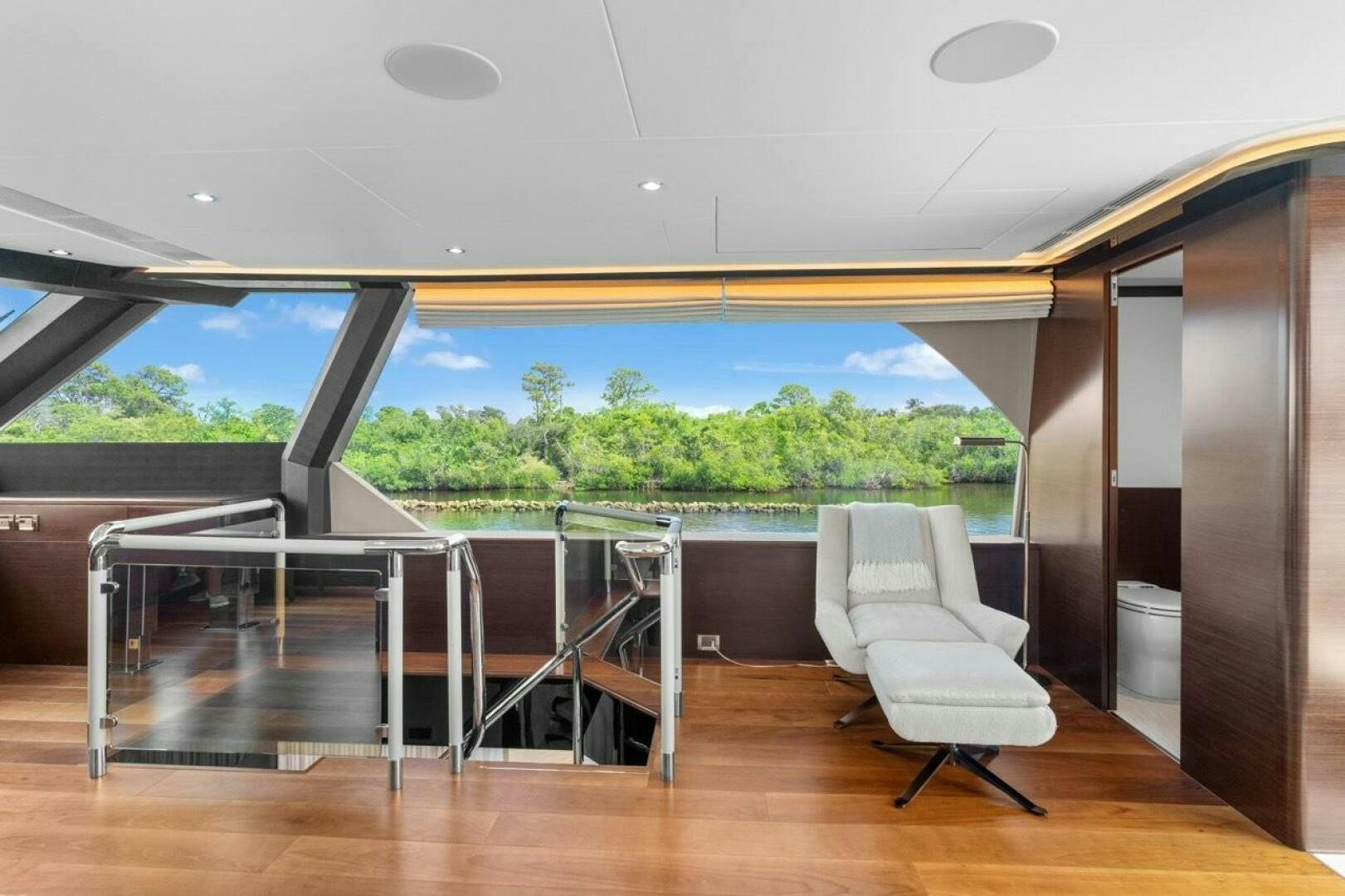 a room with a view of the water and trees aboard LADY G Yacht for Sale