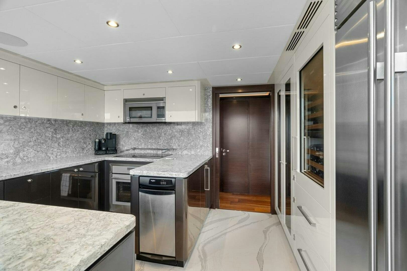 a kitchen with a fridge and a microwave aboard LADY G Yacht for Sale