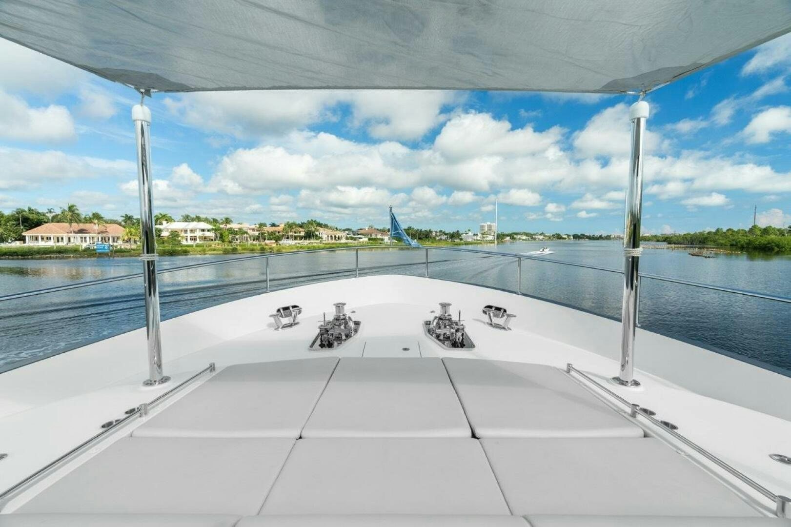 a white tiled floor by a body of water with buildings in the background aboard LADY G Yacht for Sale