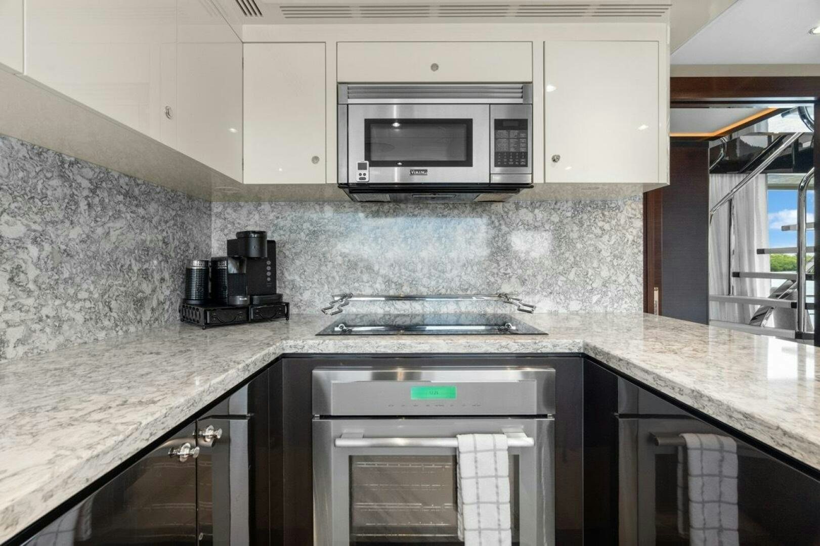 a kitchen with a microwave oven and a sink aboard LADY G Yacht for Sale