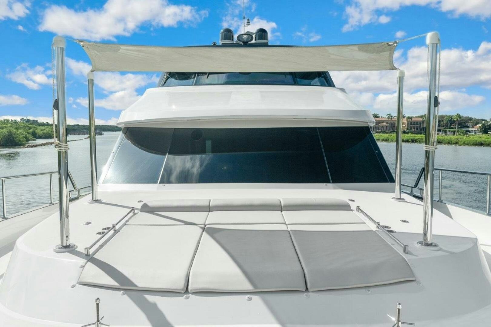 a white boat on a dock aboard LADY G Yacht for Sale