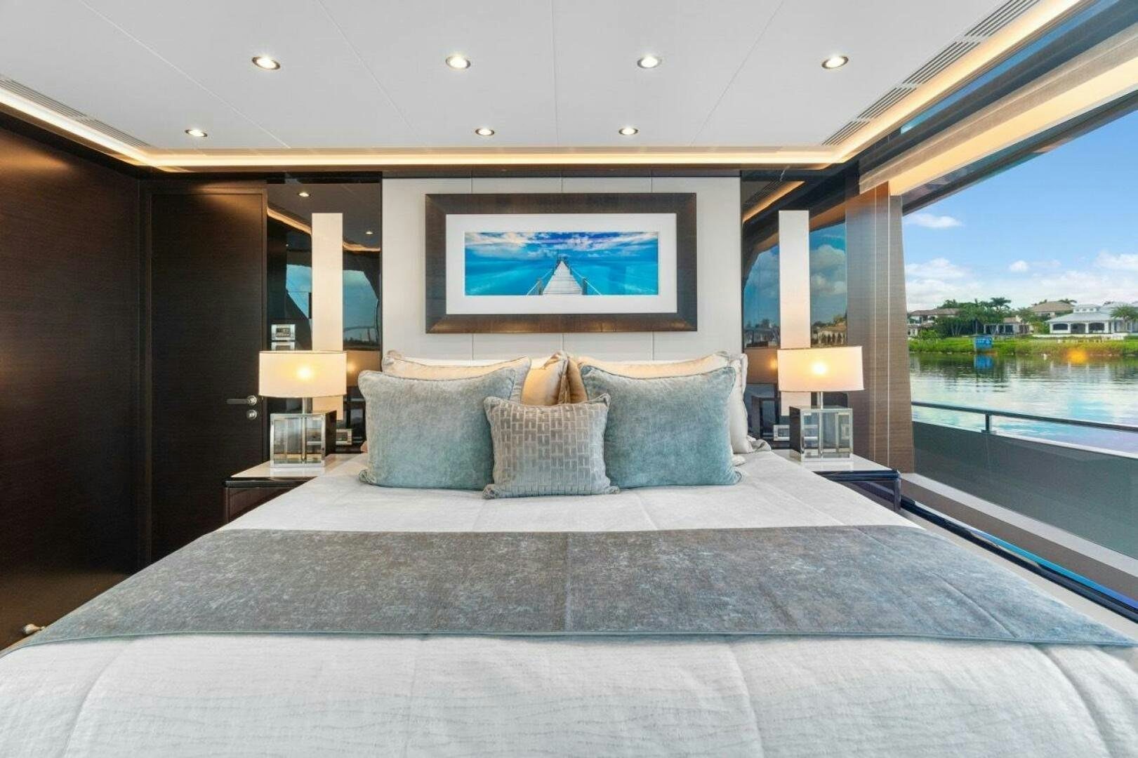 a bed with a large blue bed spread aboard LADY G Yacht for Sale