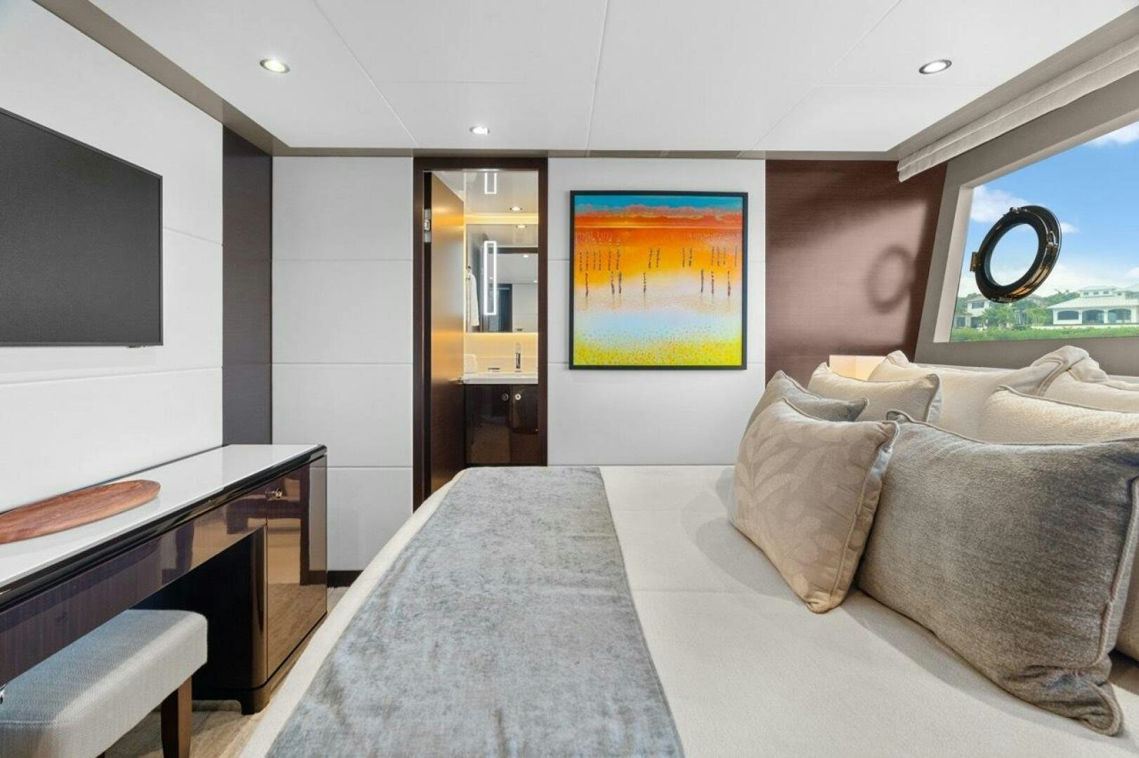 a bedroom with a bed and a desk aboard LADY G Yacht for Sale