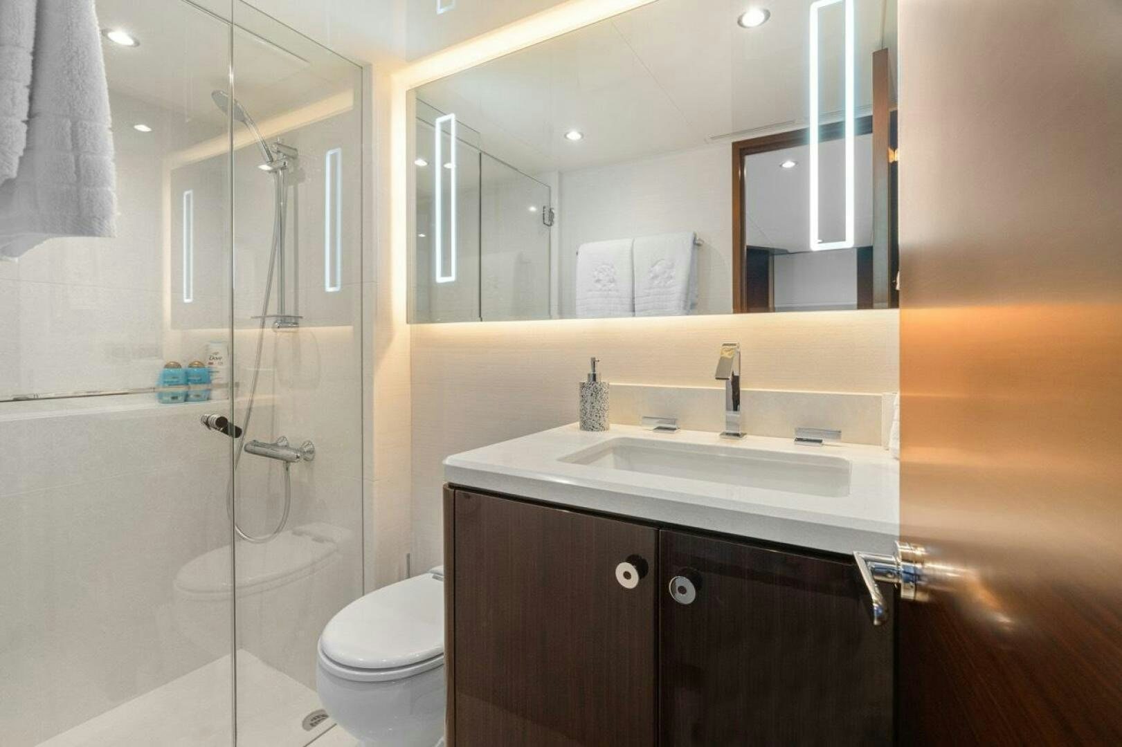 a bathroom with a glass shower aboard LADY G Yacht for Sale