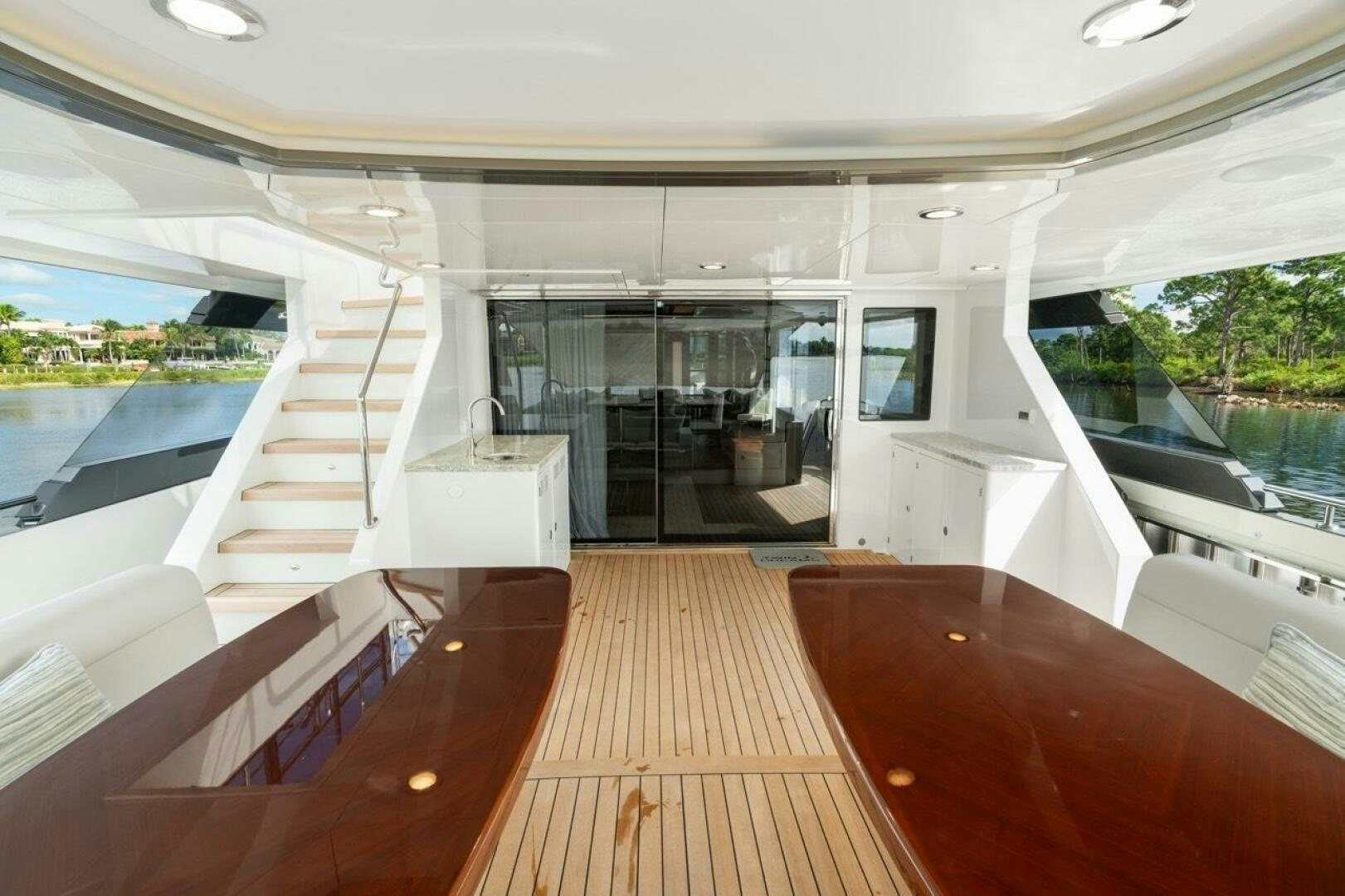 a room with a wood floor and a large window with a view of the water and the outside aboard LADY G Yacht for Sale