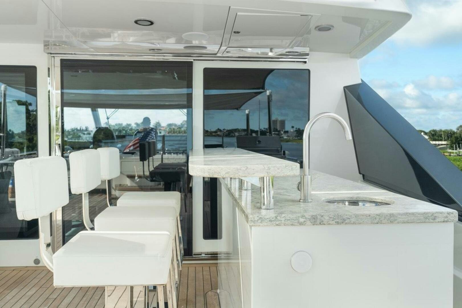 a room with a table and chairs aboard LADY G Yacht for Sale
