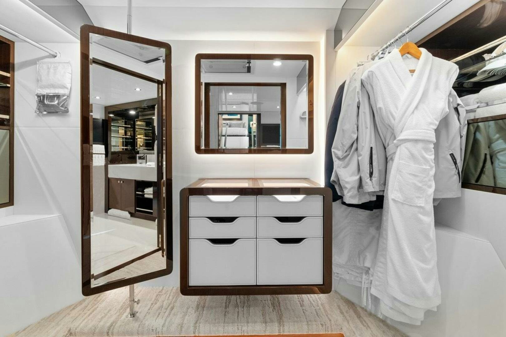 a closet with clothes on it aboard LADY G Yacht for Sale