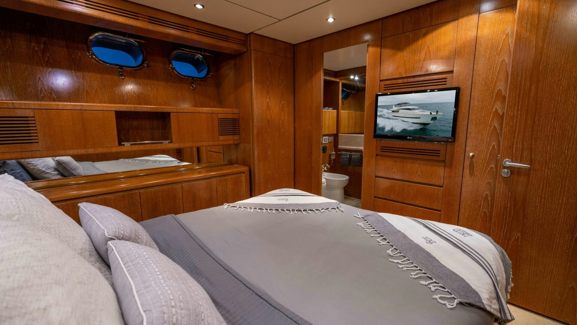 a room with a bed and a television aboard LOSAND Yacht for Sale