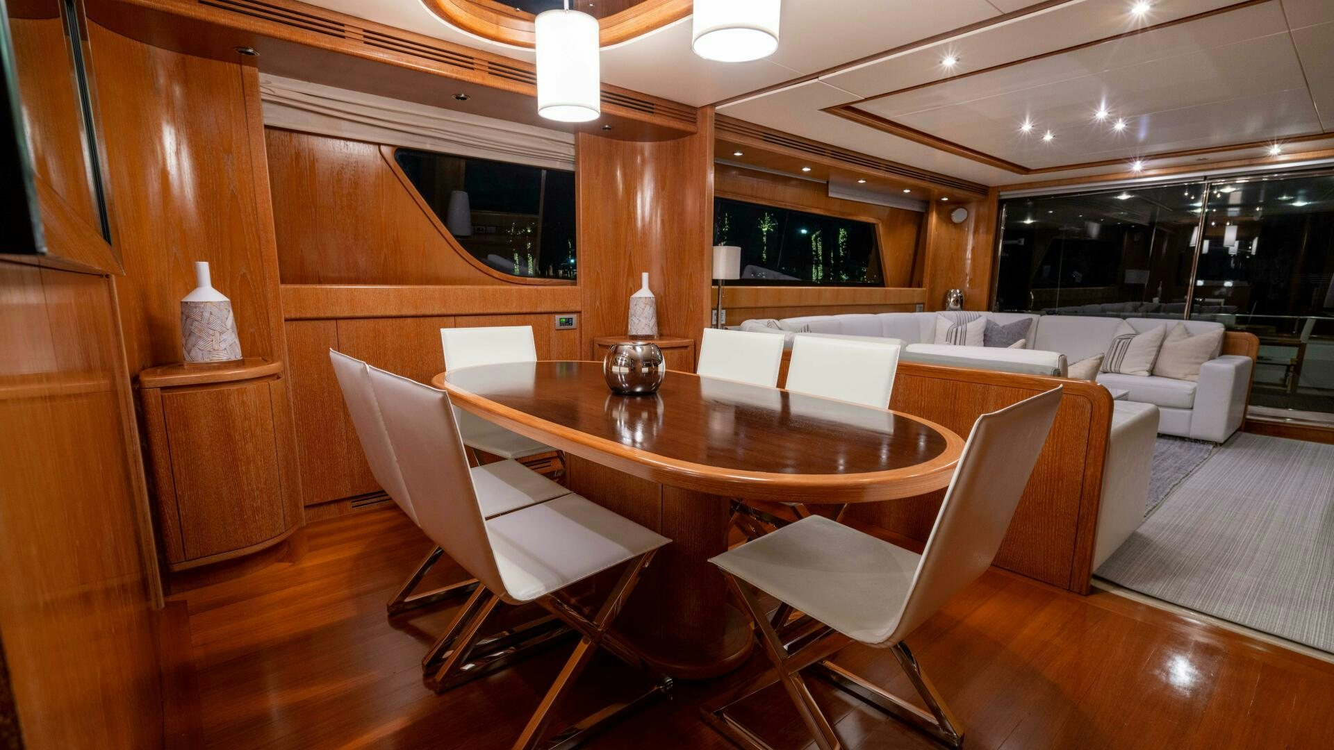a room with a table chairs and a couch aboard LOSAND Yacht for Sale