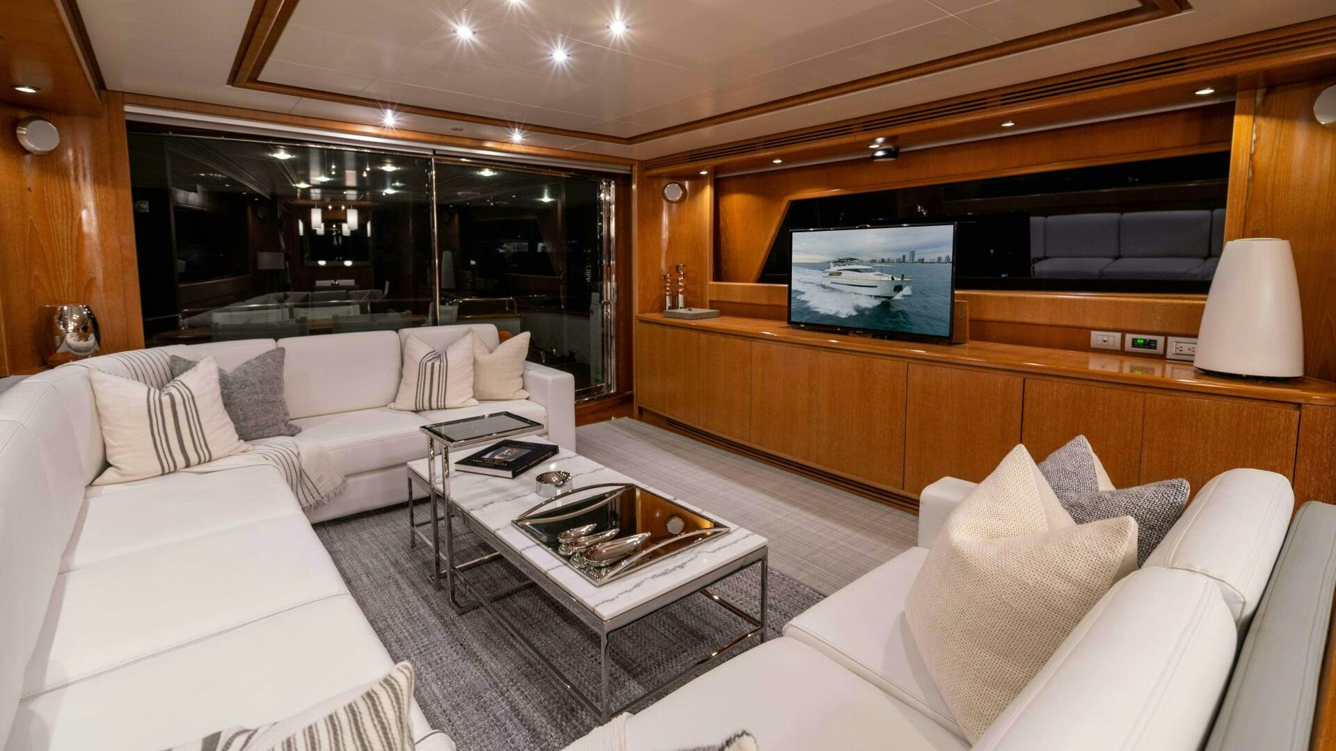 a living room with a large screen aboard LOSAND Yacht for Sale