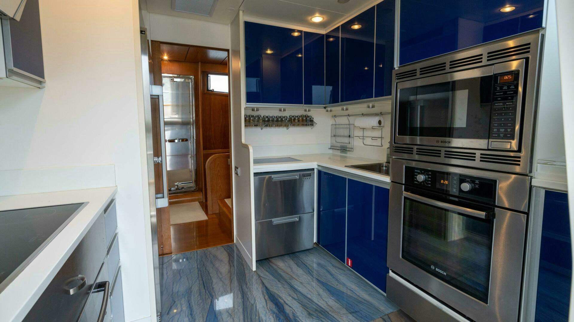 a kitchen with blue cabinets aboard LOSAND Yacht for Sale
