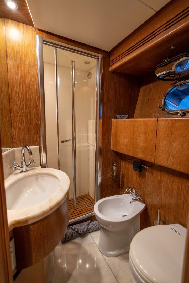 a bathroom with a shower and toilet aboard LOSAND Yacht for Sale