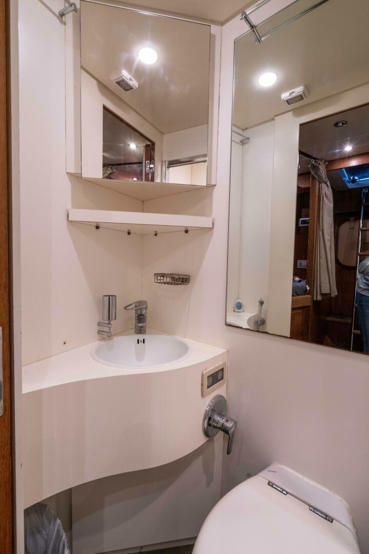 a bathroom with a sink and a toilet aboard LOSAND Yacht for Sale