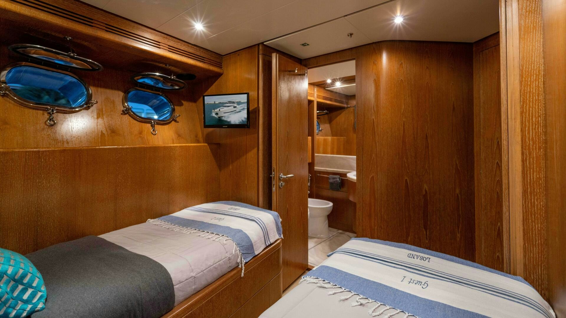 a room with a bed and a mirror aboard LOSAND Yacht for Sale