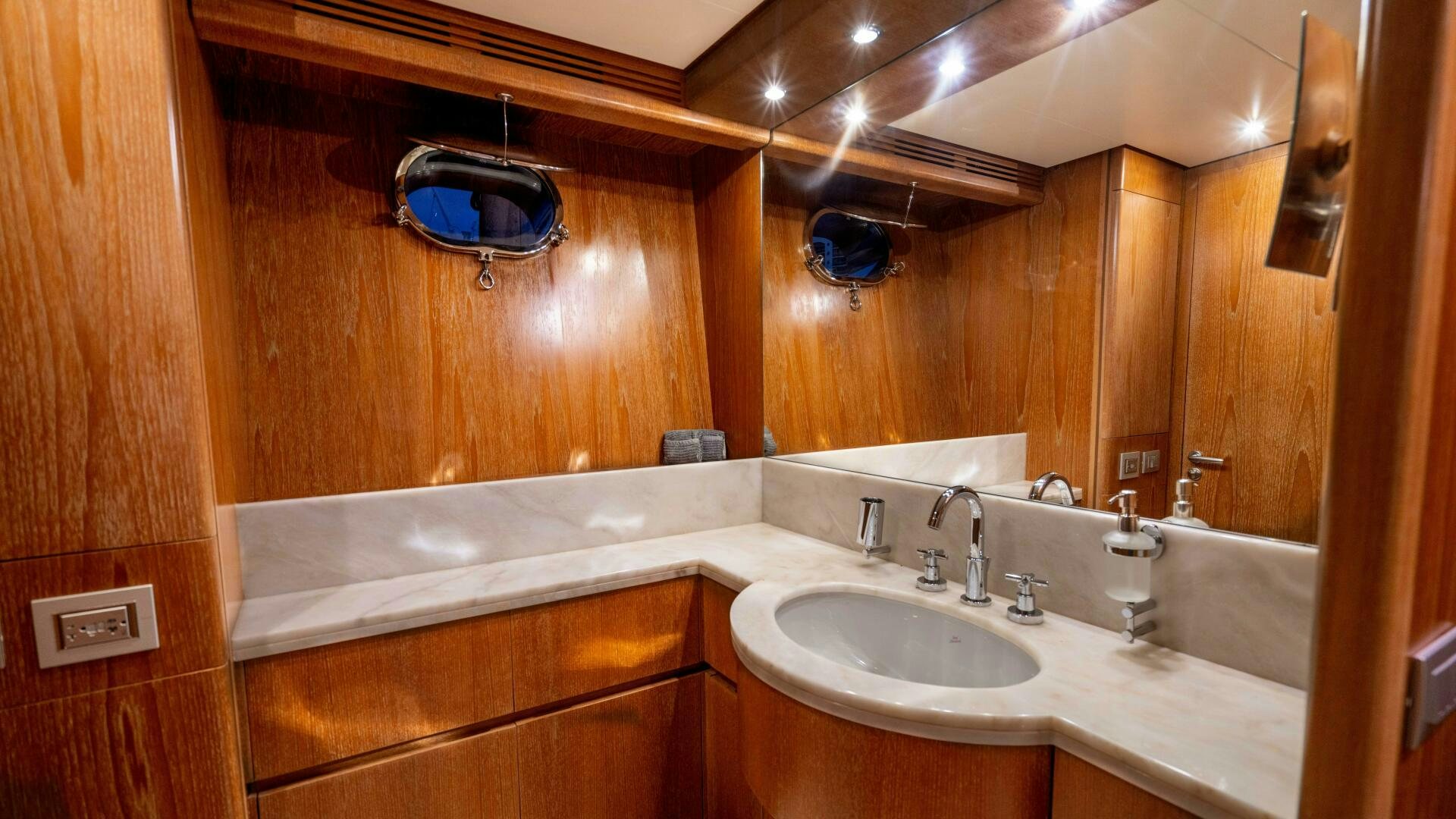 a bathroom with a sink and a mirror aboard LOSAND Yacht for Sale