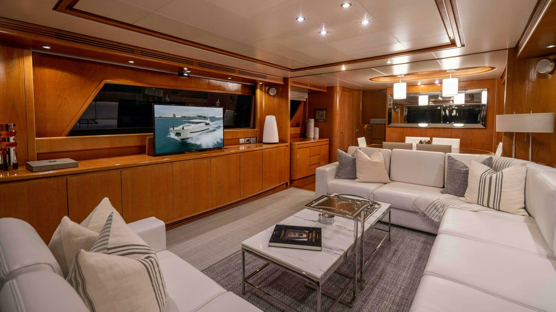 a living room with a large screen aboard LOSAND Yacht for Sale