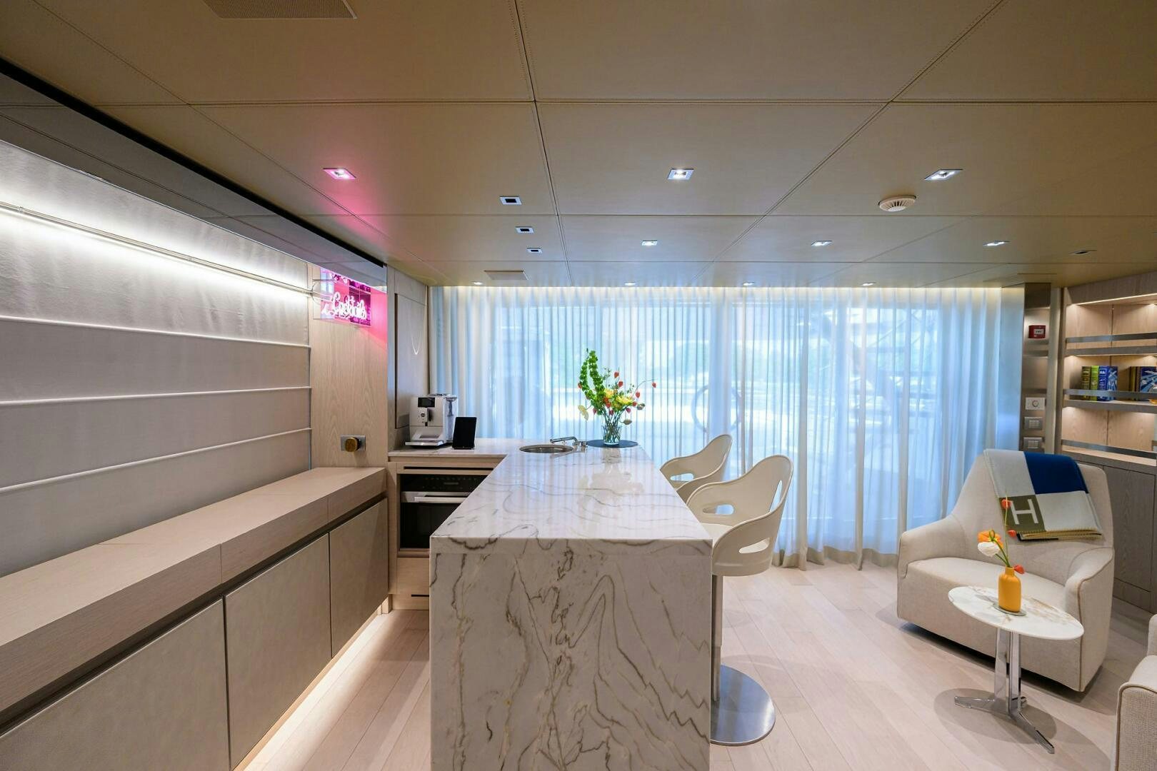 a room with a table chairs and a window aboard GLORY Yacht for Sale