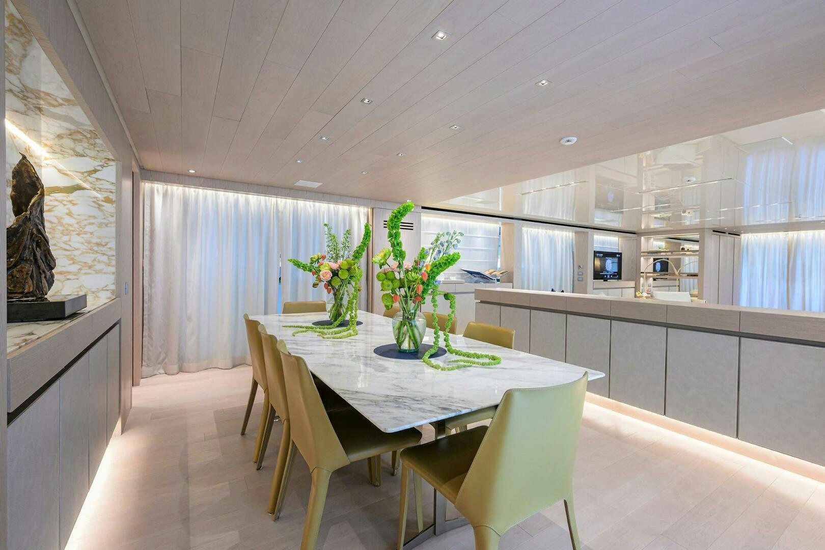 a large kitchen with a table and chairs aboard GLORY Yacht for Sale