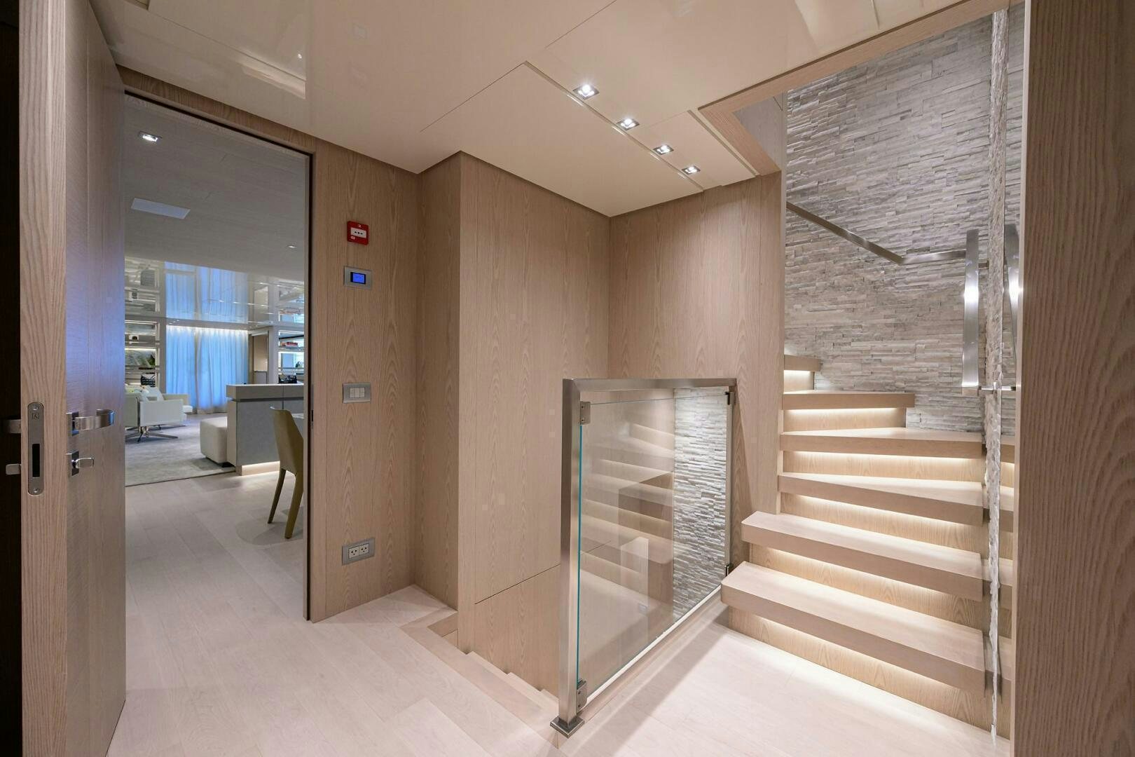 a hallway with a door and a staircase aboard GLORY Yacht for Sale
