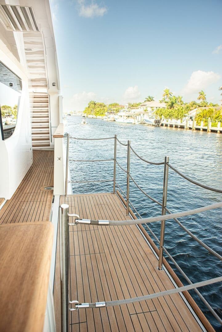a deck with a railing and a boat on it aboard GLORY Yacht for Sale