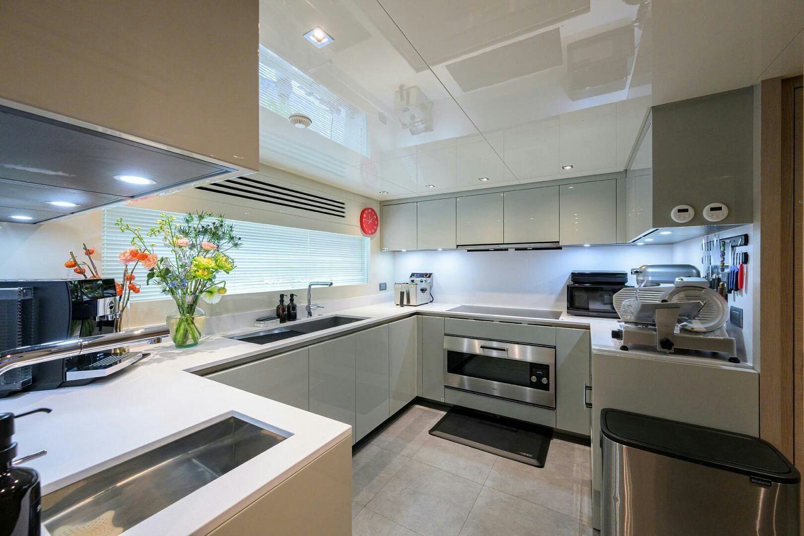 a kitchen with white cabinets aboard GLORY Yacht for Sale