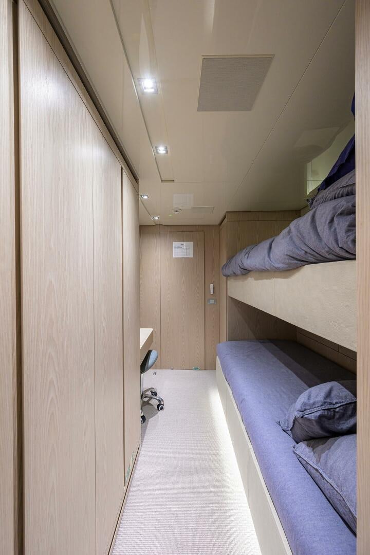 a room with beds and a door aboard GLORY Yacht for Sale