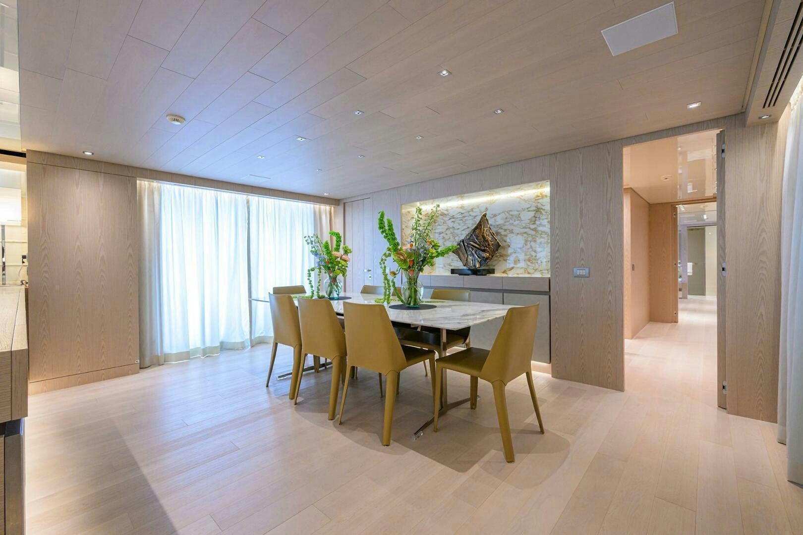 a room with a table and chairs aboard GLORY Yacht for Sale