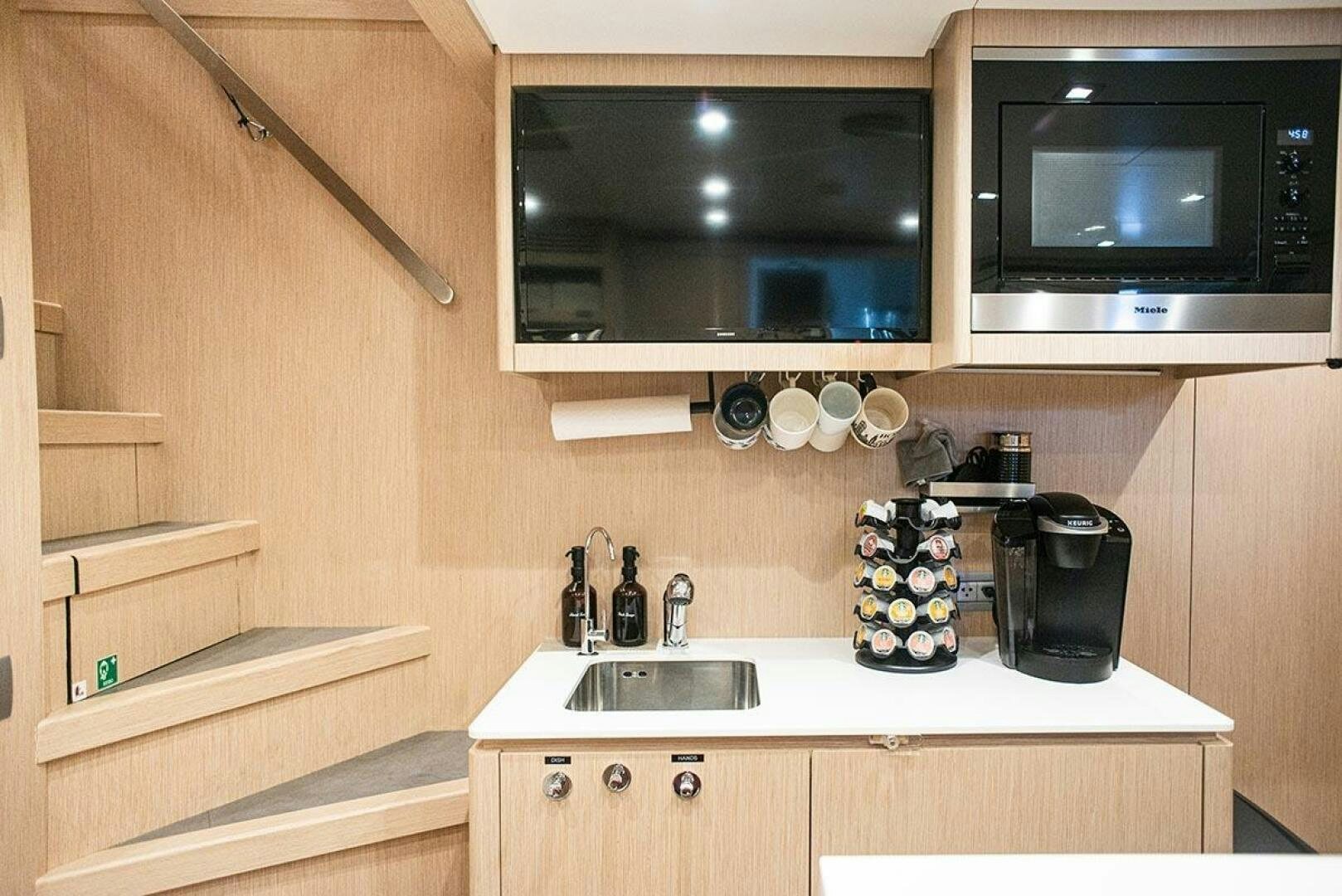a kitchen with a microwave oven and a sink aboard GLORY Yacht for Sale