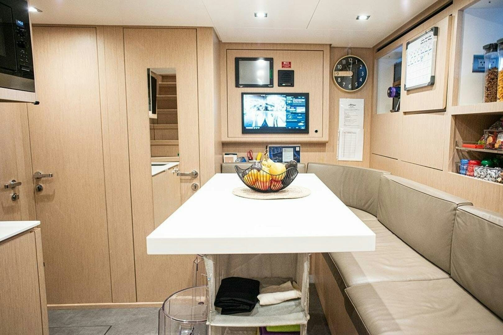 a room with a table and tv aboard GLORY Yacht for Sale