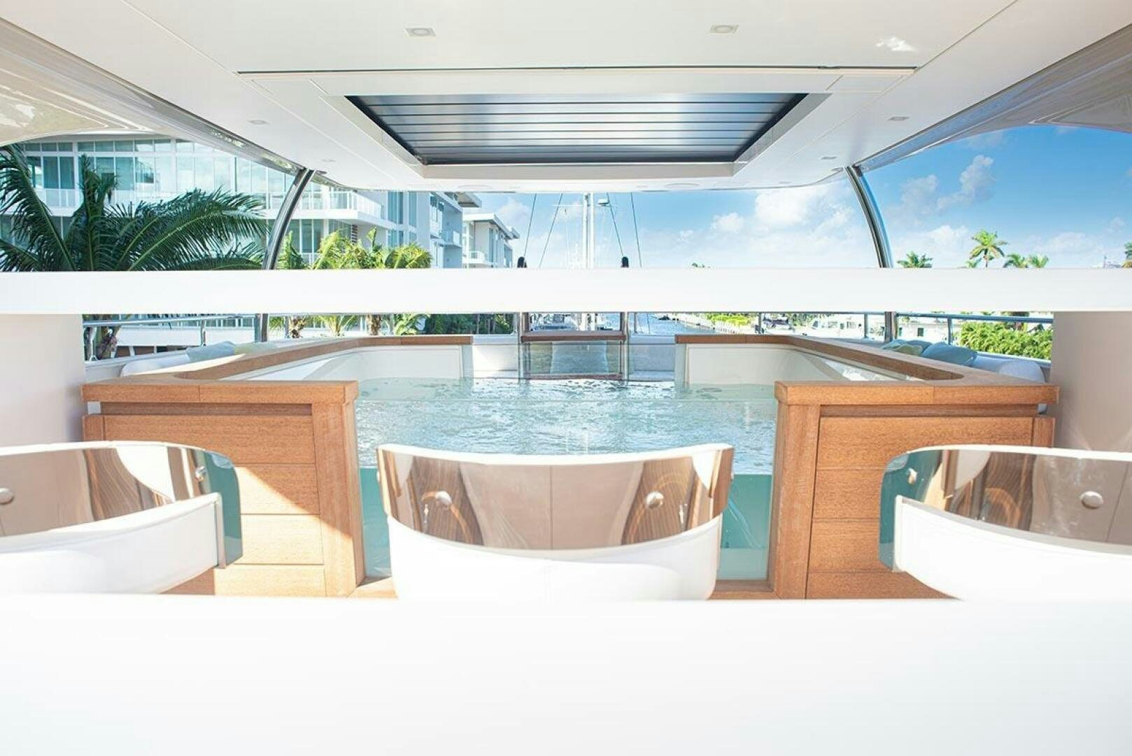 a room with a pool and chairs aboard GLORY Yacht for Sale