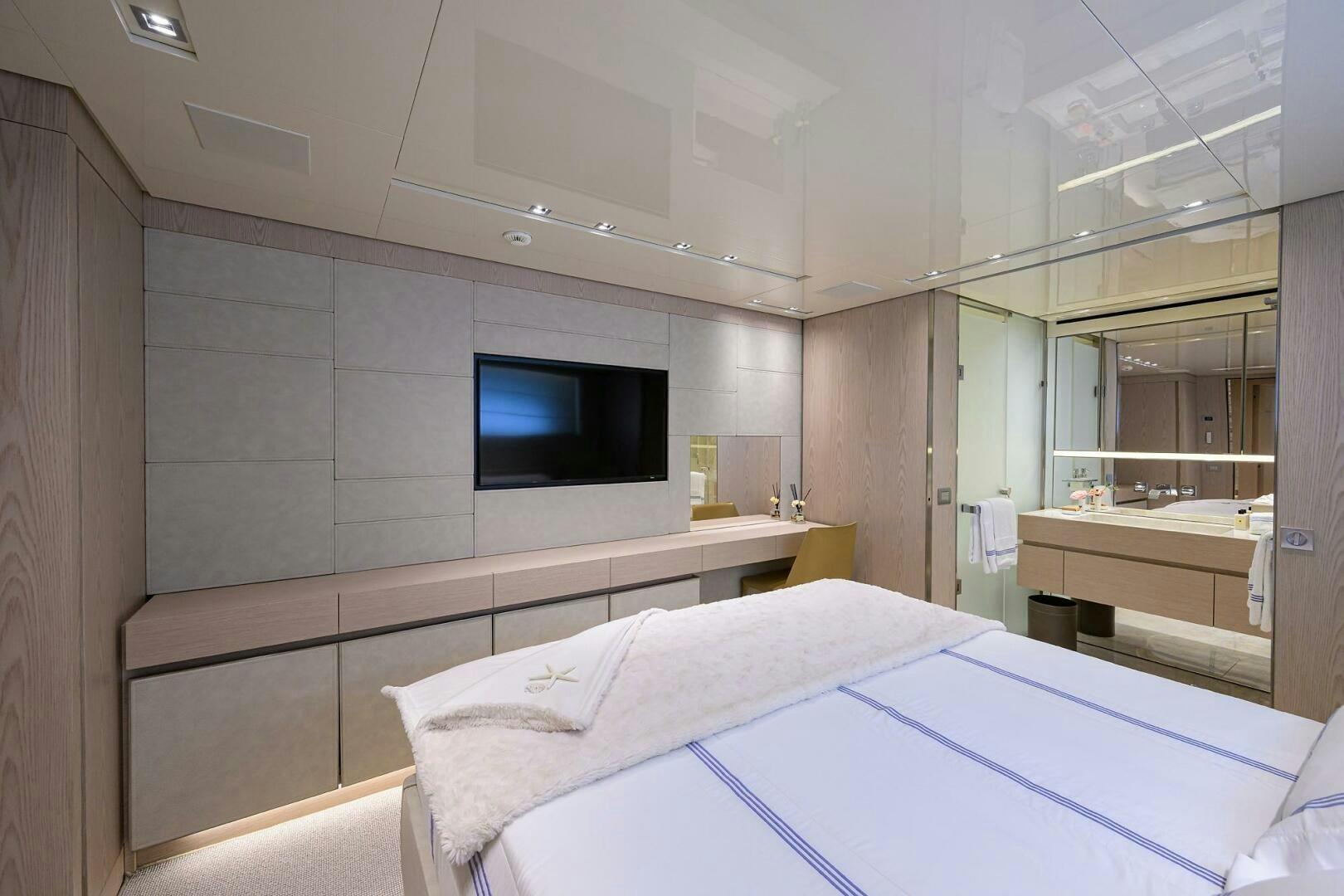 a room with a bed and a tv aboard GLORY Yacht for Sale