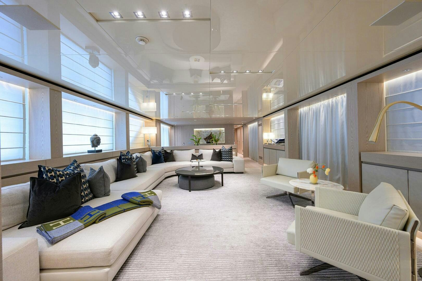 a large living room with white furniture aboard GLORY Yacht for Sale