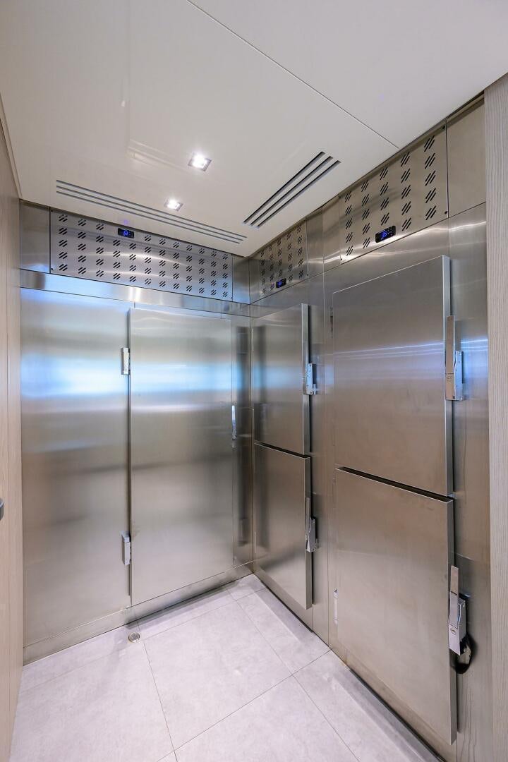 a large room with silver lockers aboard GLORY Yacht for Sale