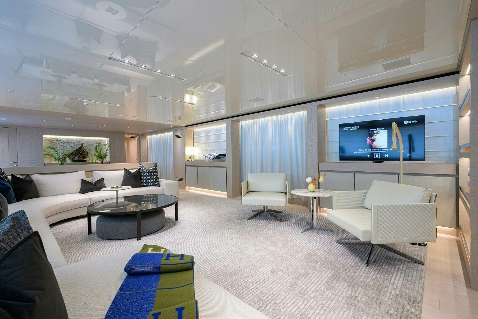 a living room with a large screen aboard GLORY Yacht for Sale
