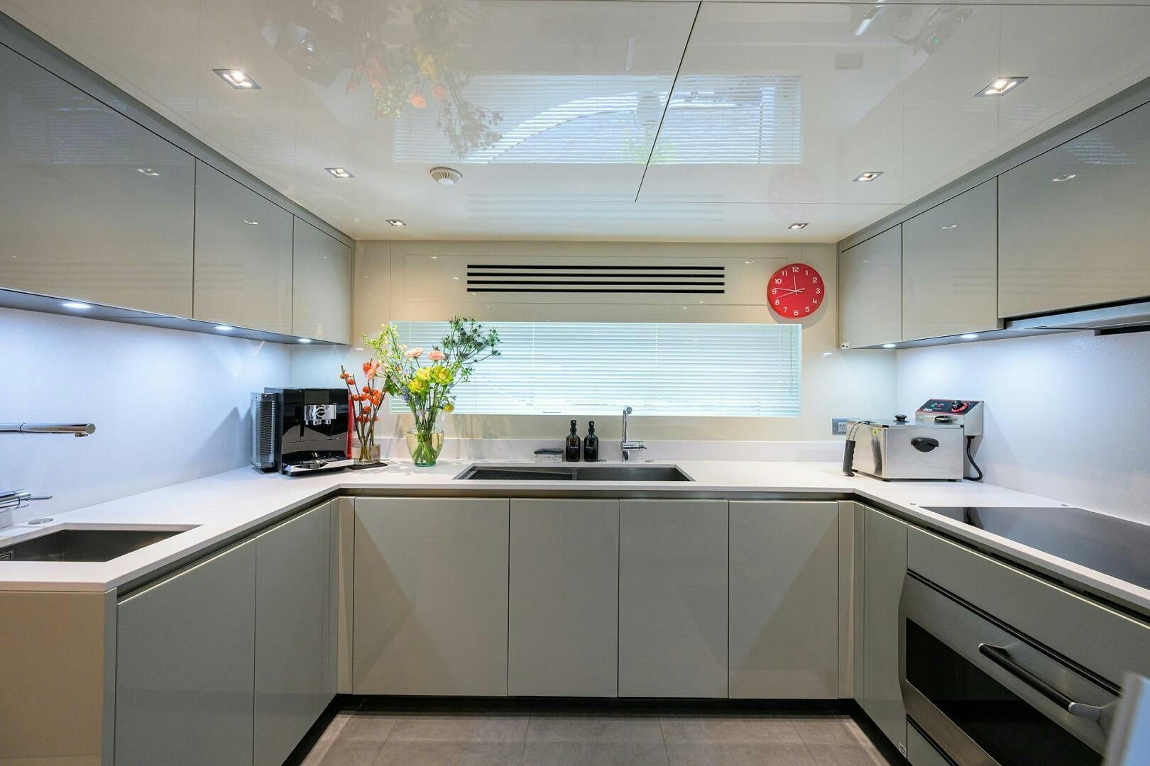a kitchen with white cabinets aboard GLORY Yacht for Sale