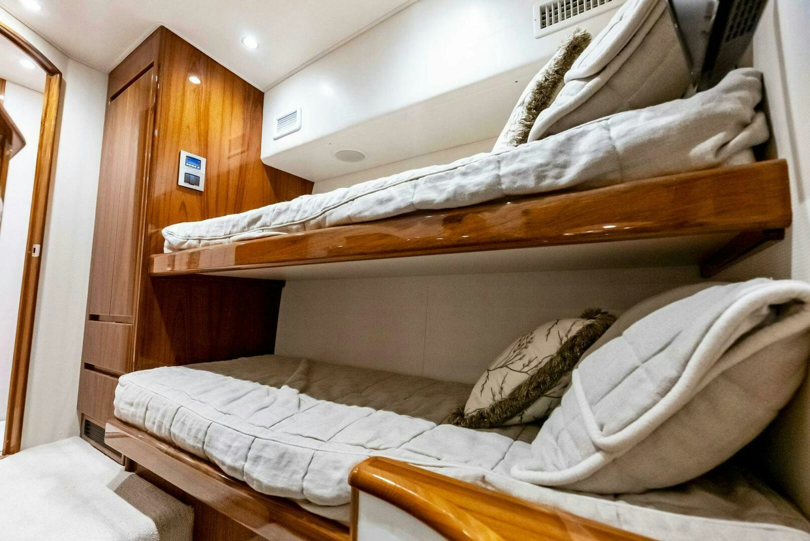 a couple of beds in a room aboard PRINCESS LILY Yacht for Sale