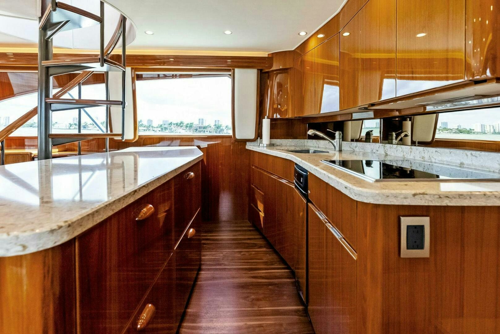 a kitchen with wooden cabinets aboard PRINCESS LILY Yacht for Sale