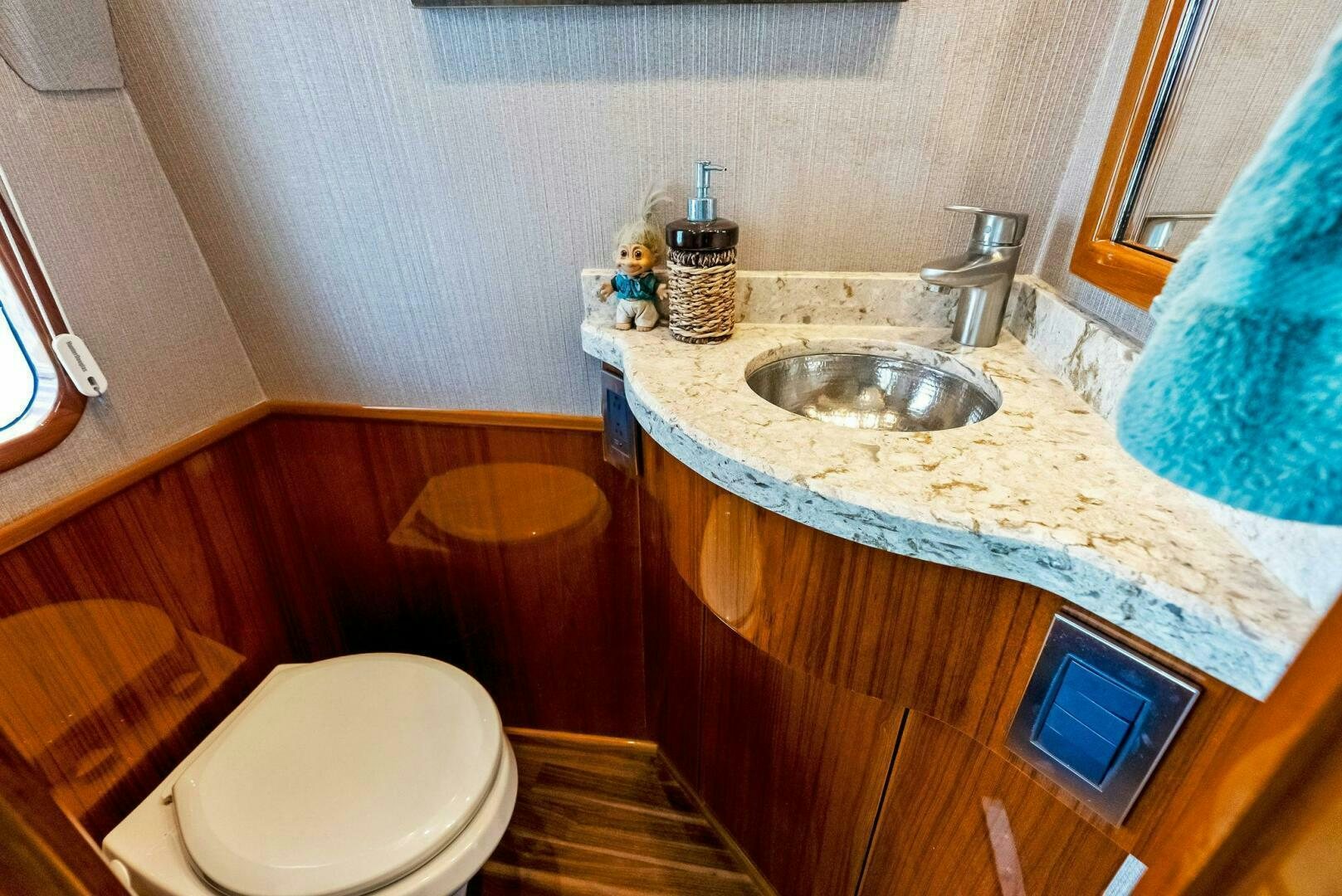 a bathroom with a sink and a toilet aboard PRINCESS LILY Yacht for Sale