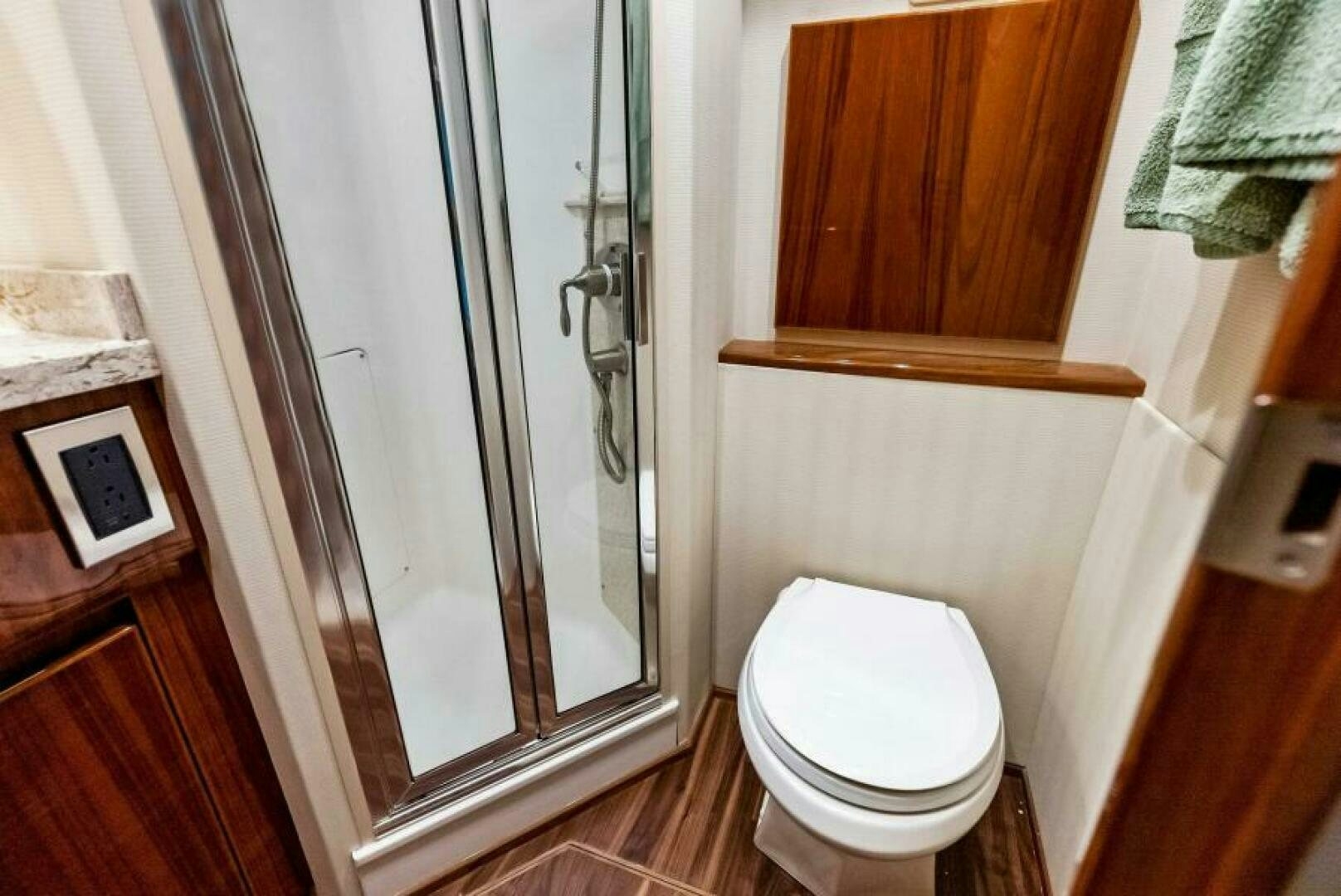 a bathroom with a glass shower door aboard PRINCESS LILY Yacht for Sale