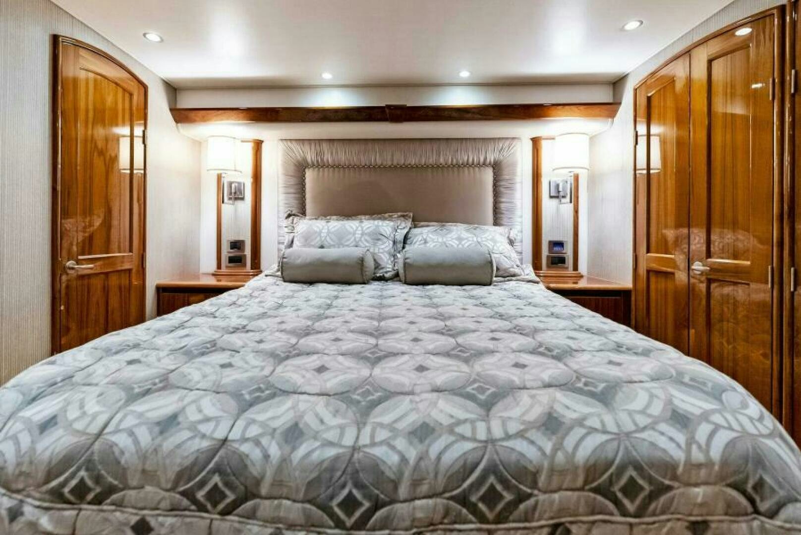 a bed with a blue comforter aboard PRINCESS LILY Yacht for Sale