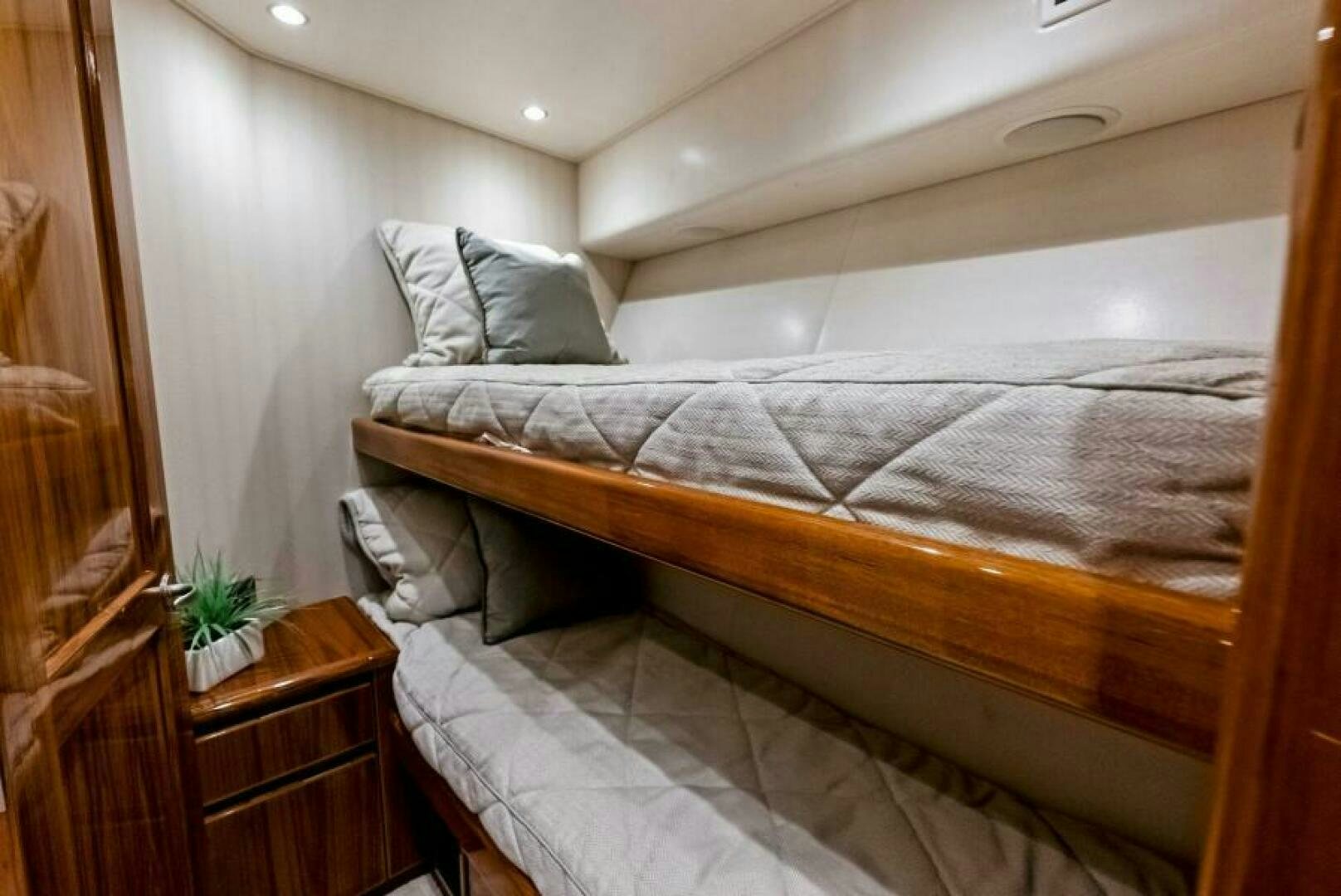 a bed with a white comforter aboard PRINCESS LILY Yacht for Sale