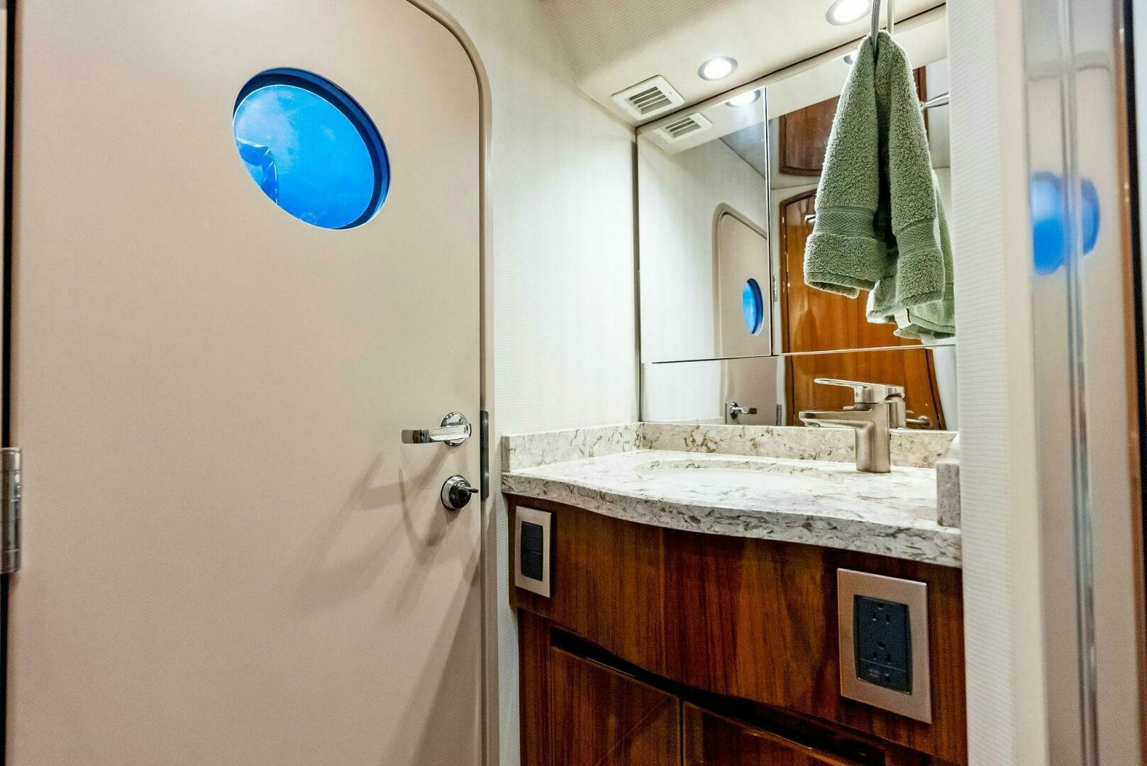 a bathroom with a sink and a mirror aboard PRINCESS LILY Yacht for Sale