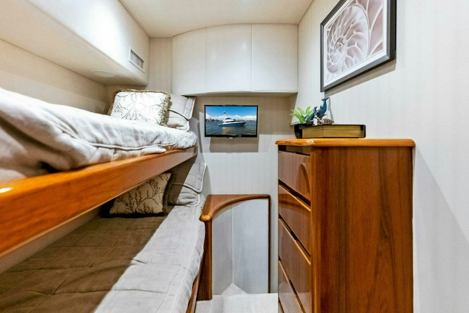 a small bedroom with a small bed aboard PRINCESS LILY Yacht for Sale