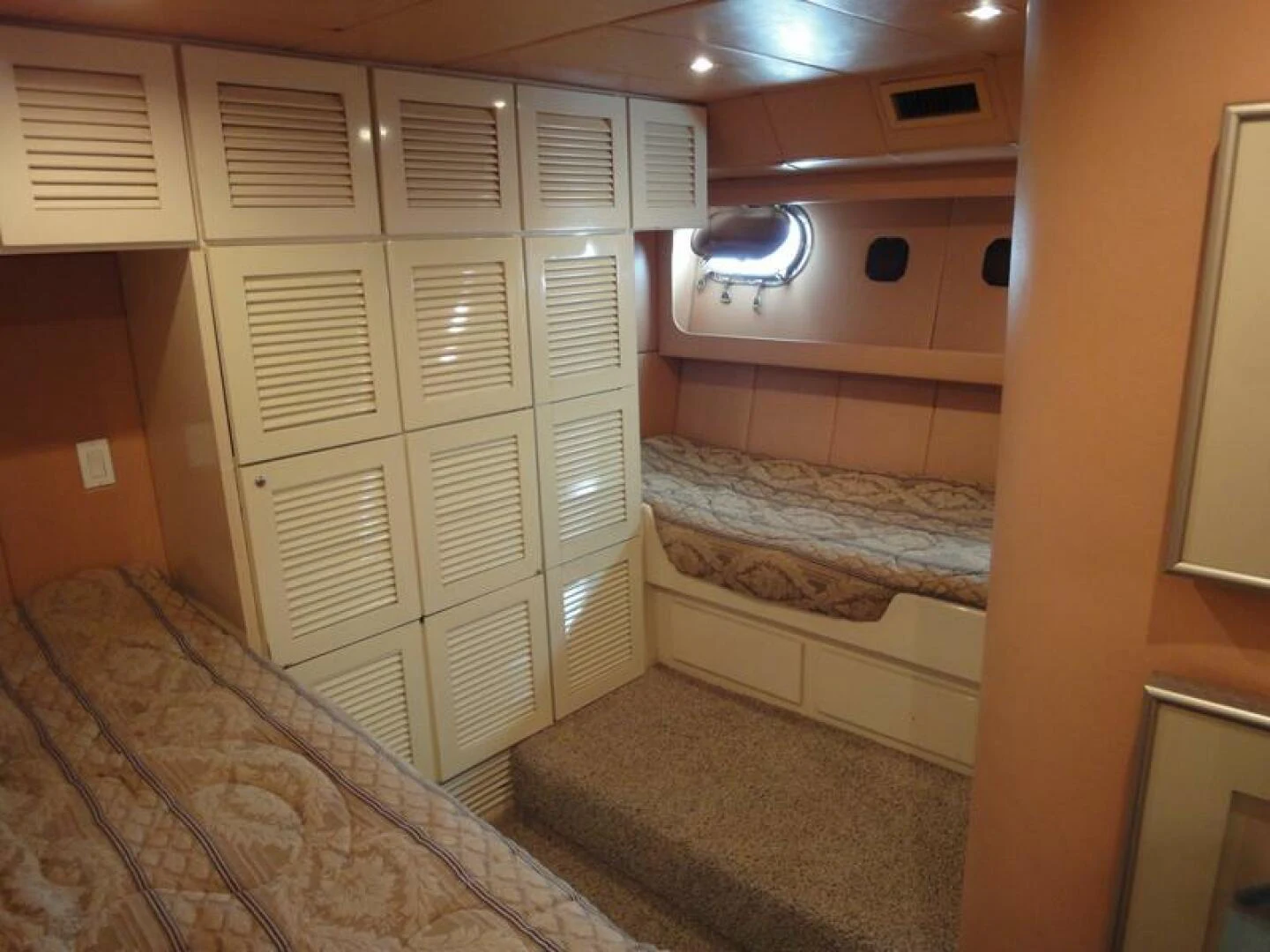 a room with a bed and a closet aboard PIER PRESSURE Yacht for Sale