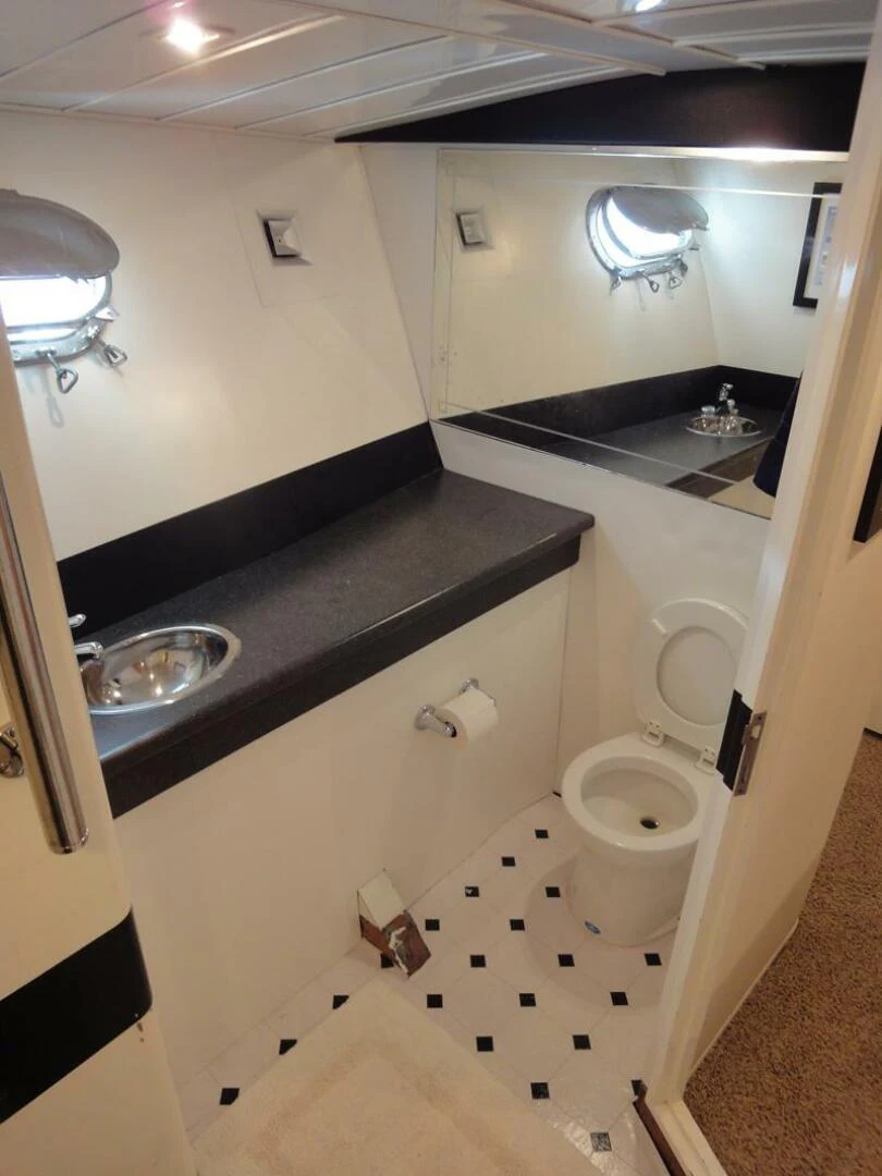 a bathroom with a sink and a toilet aboard PIER PRESSURE Yacht for Sale