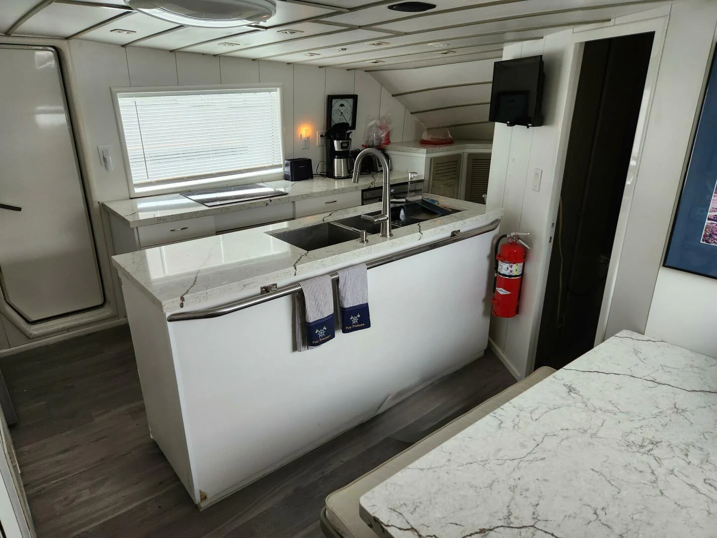 a kitchen with a sink and a window aboard PIER PRESSURE Yacht for Sale