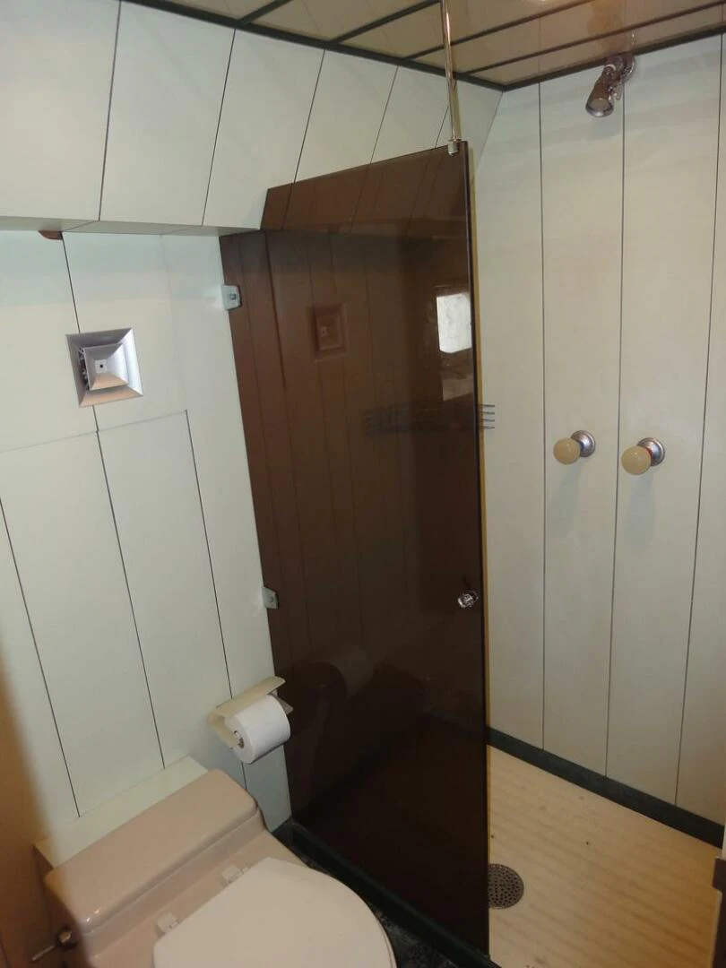 a bathroom with a toilet and a shower aboard PIER PRESSURE Yacht for Sale