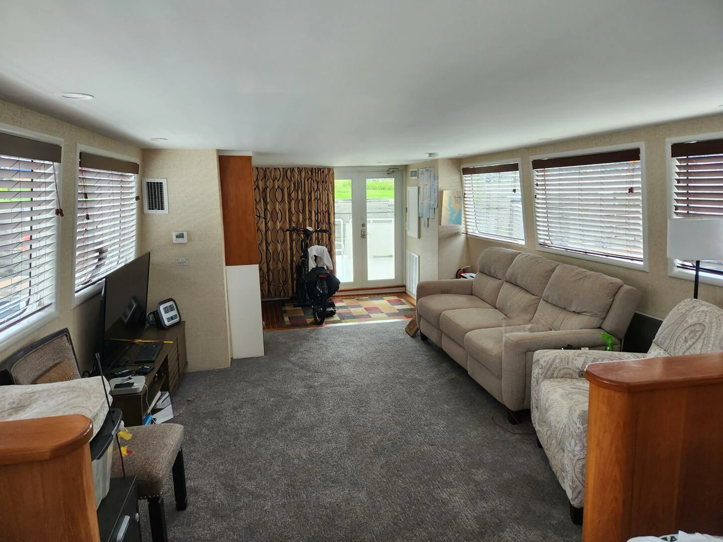 a living room with a couch and a television aboard PIER PRESSURE Yacht for Sale
