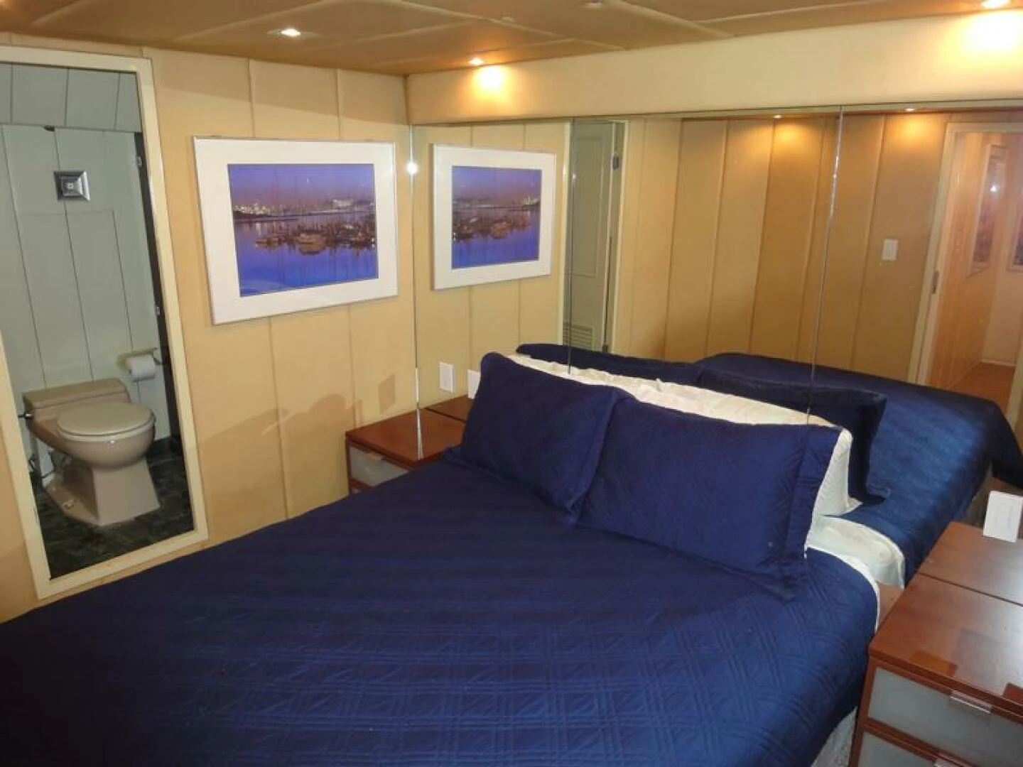 a bed with blue sheets aboard PIER PRESSURE Yacht for Sale